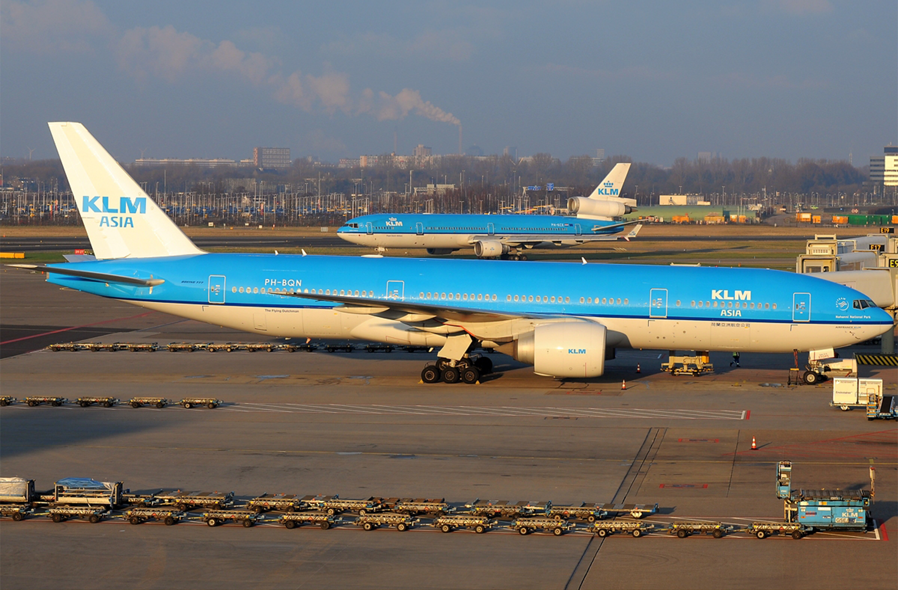 Un Boeing 777-200ER y al fondo un MD-11 (ya retirado) de KLM en el aeropuerto de Ámsterdam, en Países Bajos.